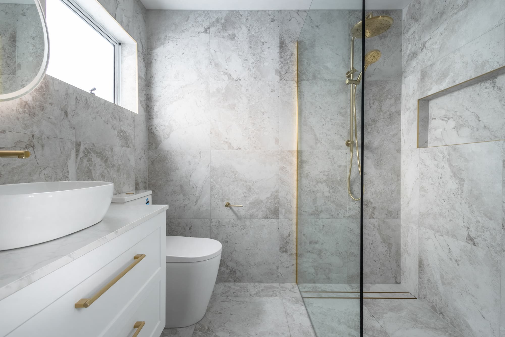 Marble bathroom with gold shower fixtures